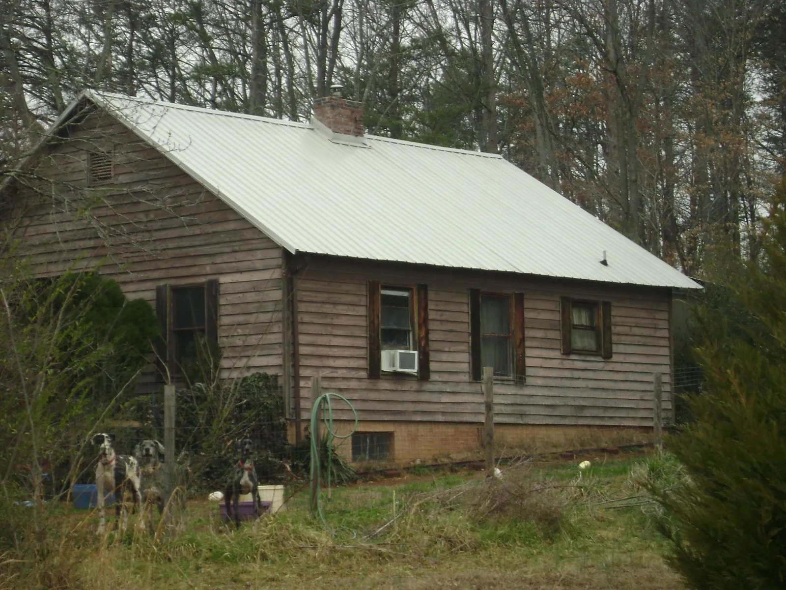 White metal roof on an old wood sided farmhouse, from a Metal Roof Installation job in Syosset